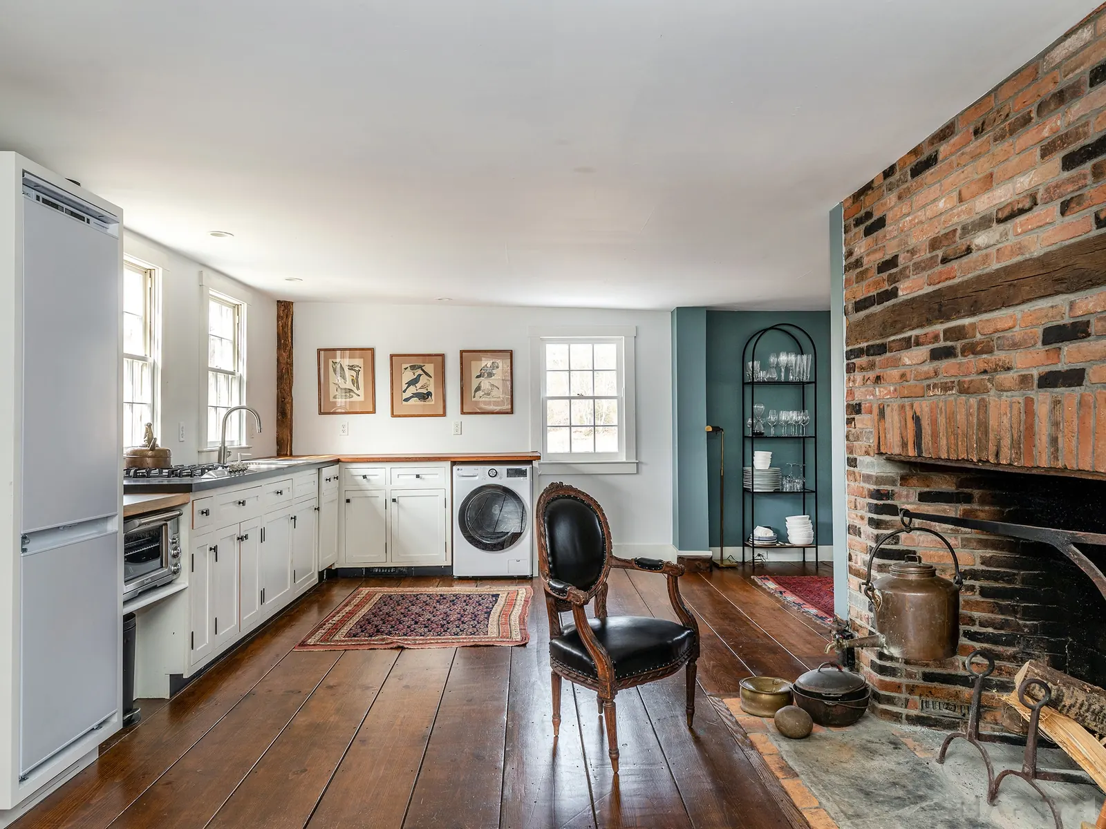 Cottage kitchen with fireplace and laundry